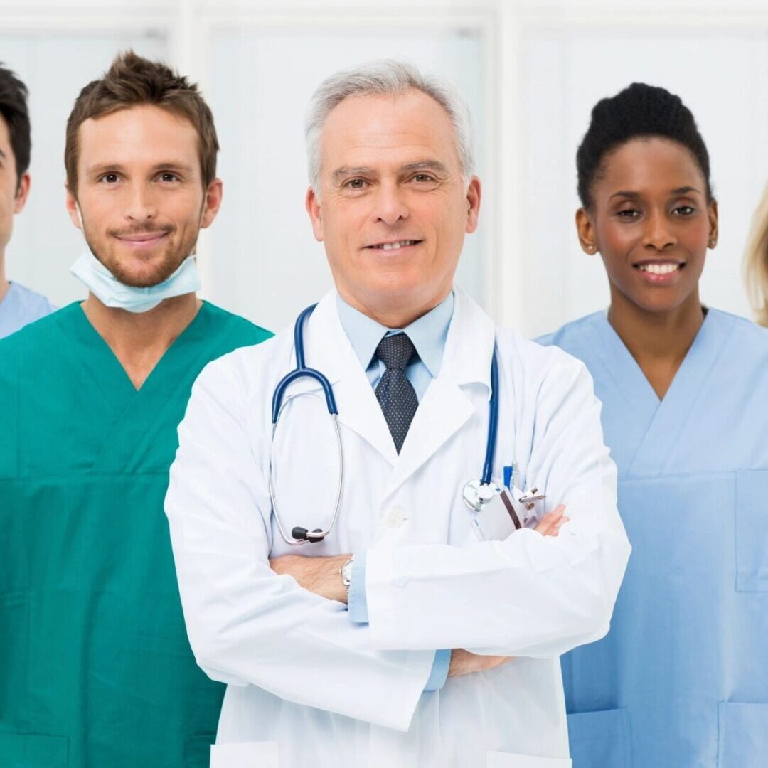 A group of doctors and nurses standing in front of each other.